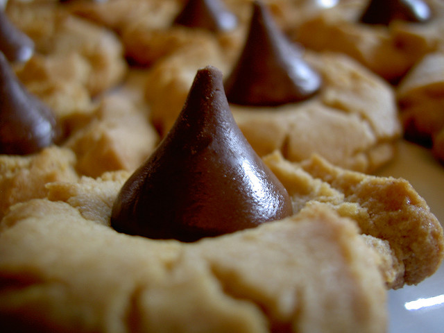 Close-up shot of Peanut Butter Blossom cookies on a cookie sheet